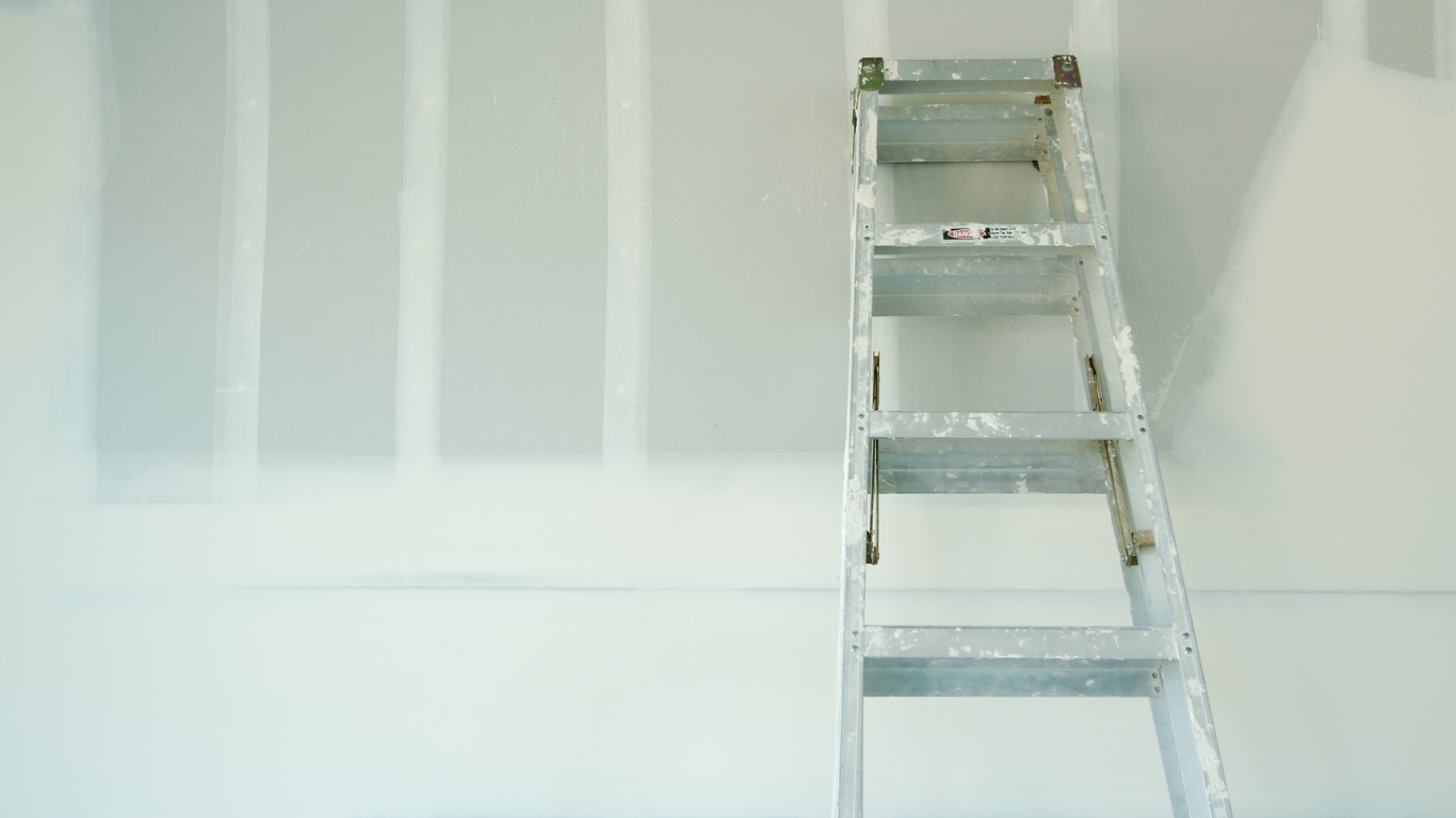 Ladder leaning against a freshly painted wall.