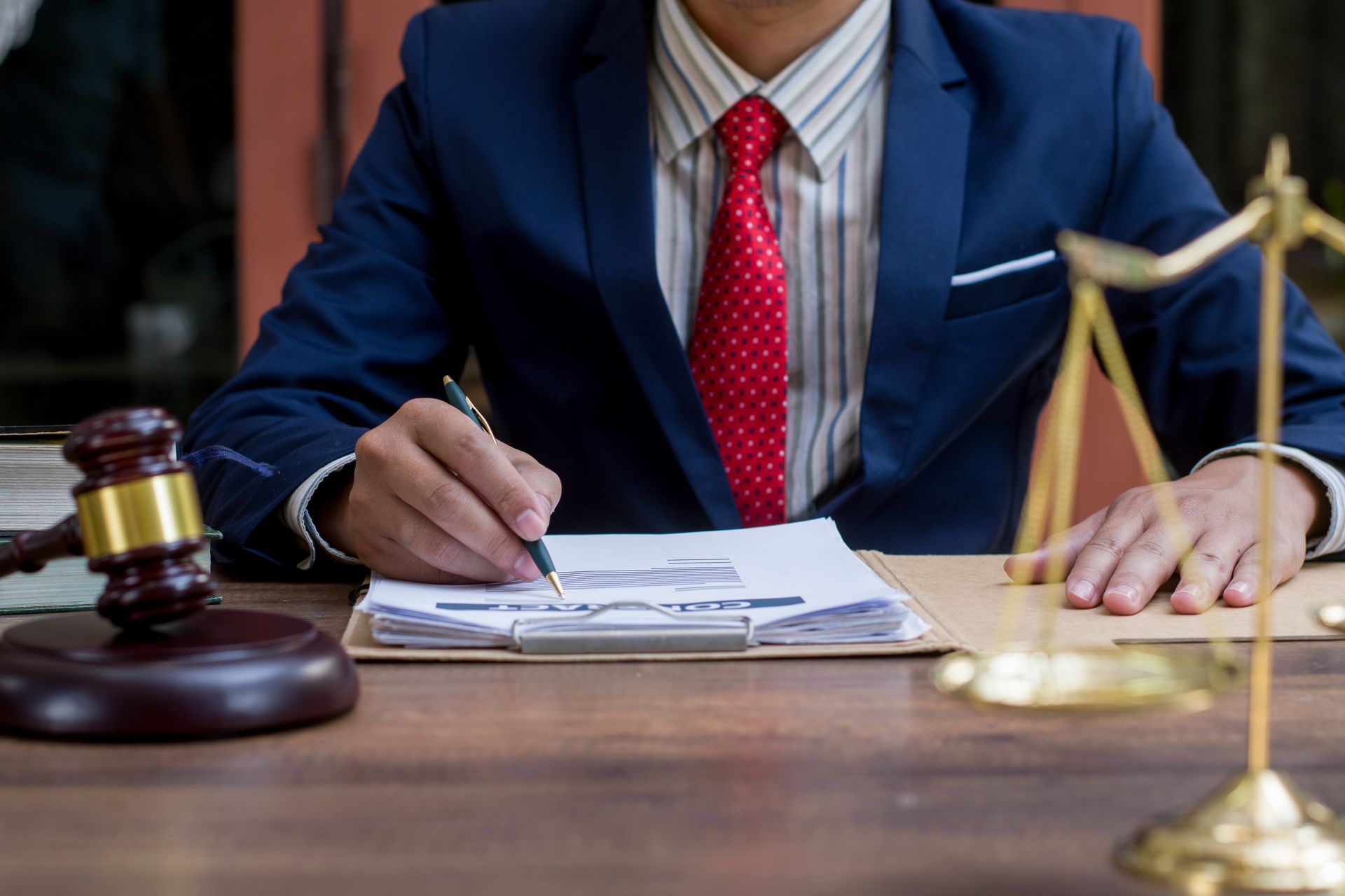 A lawyer writing on a document.