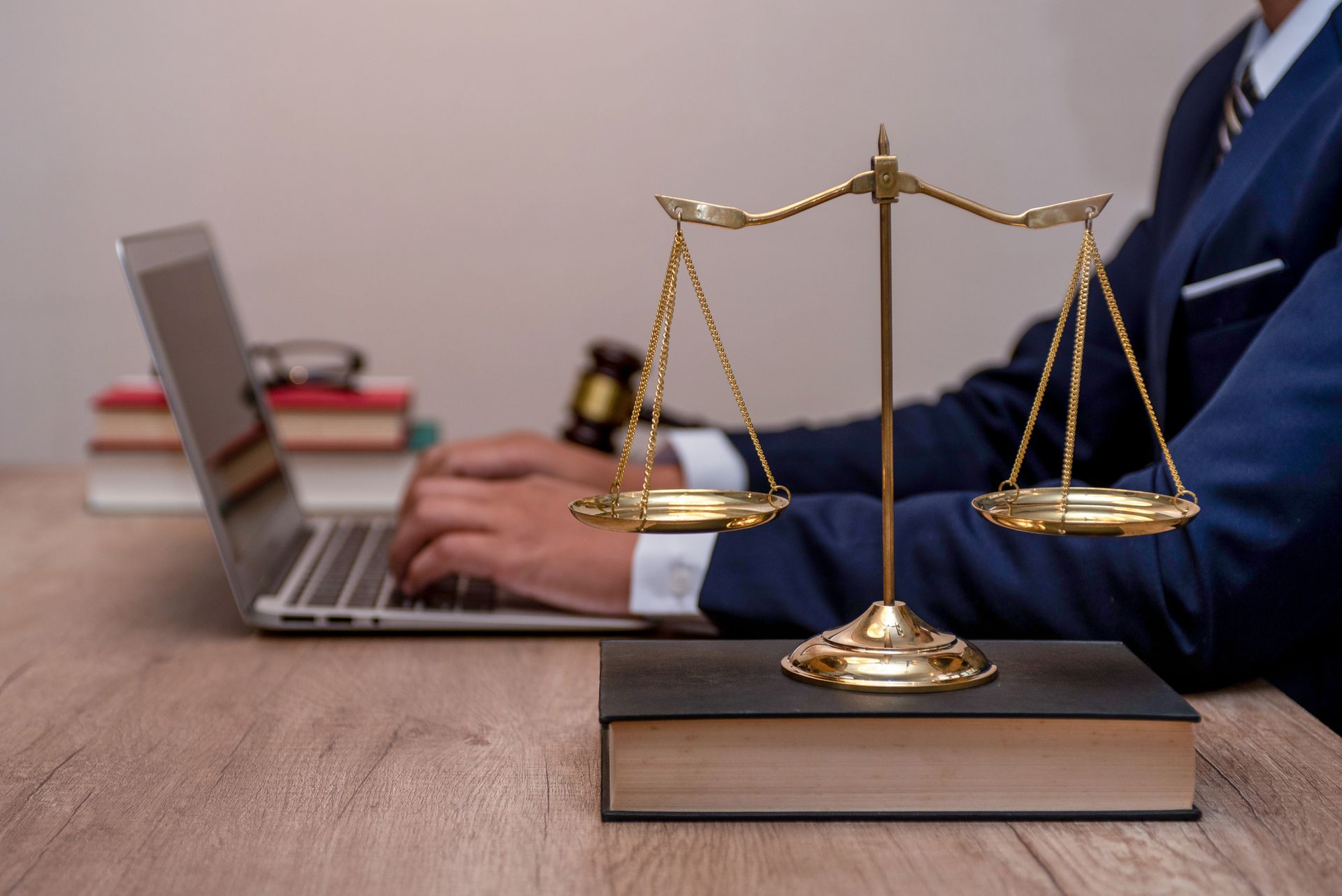 Male lawyer reviews contract papers beside gavel, symbolizing justice and legal decision-making.