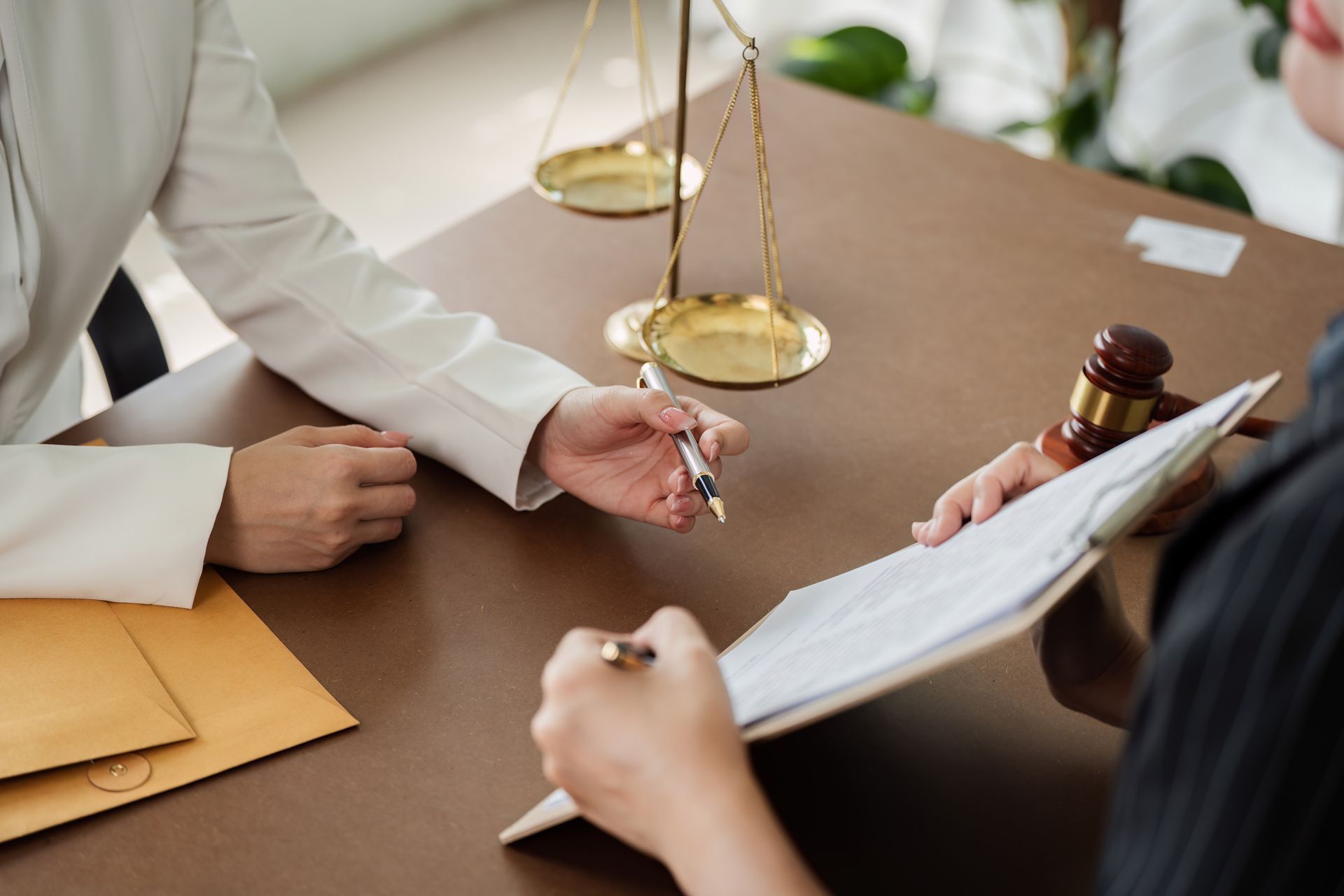 Consultation between a lawyer and client to sign paperwork. Consultation between a lawyer and client to sign paperwork.
