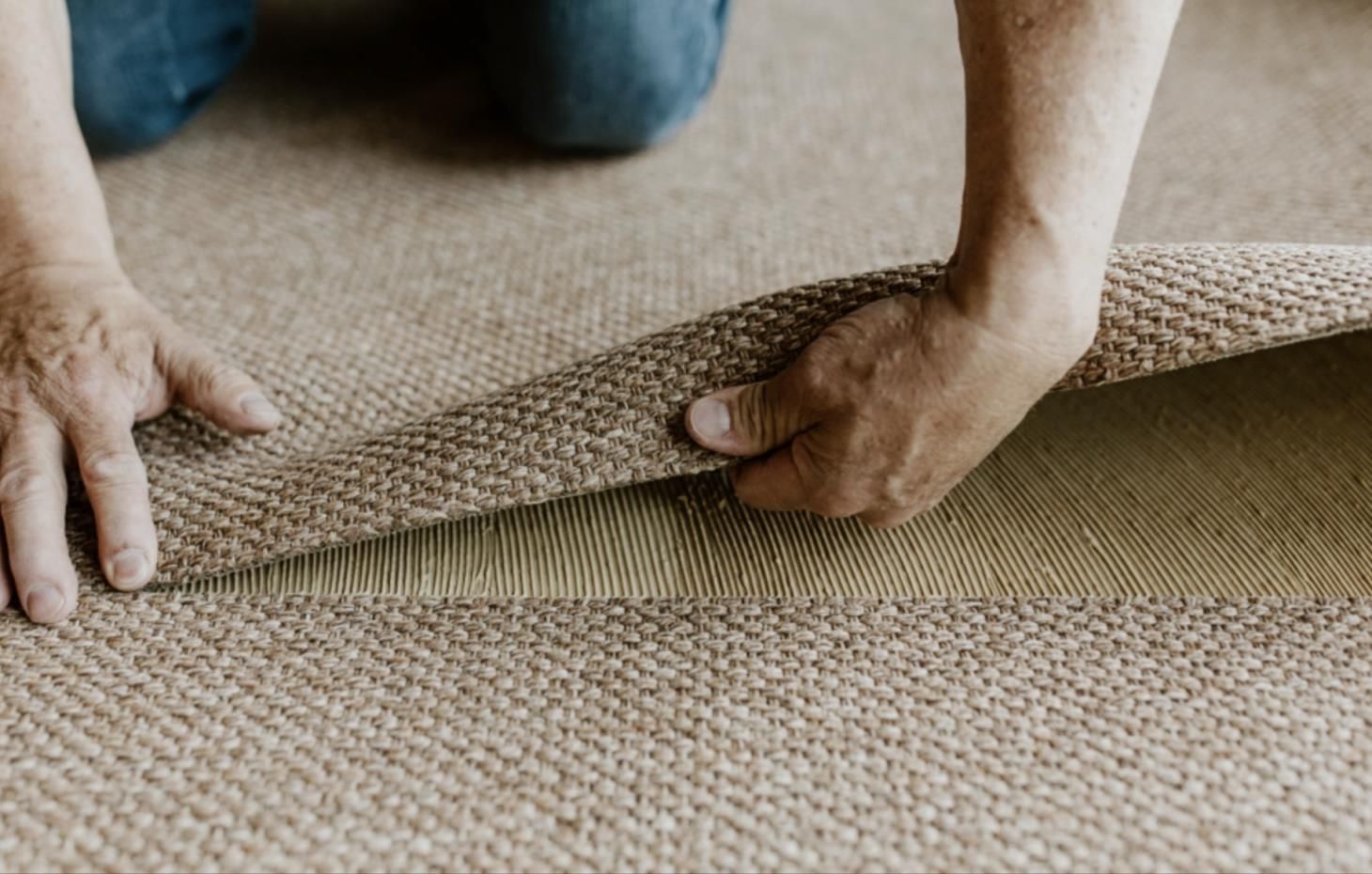 two men are carrying an oven in a kitchen .