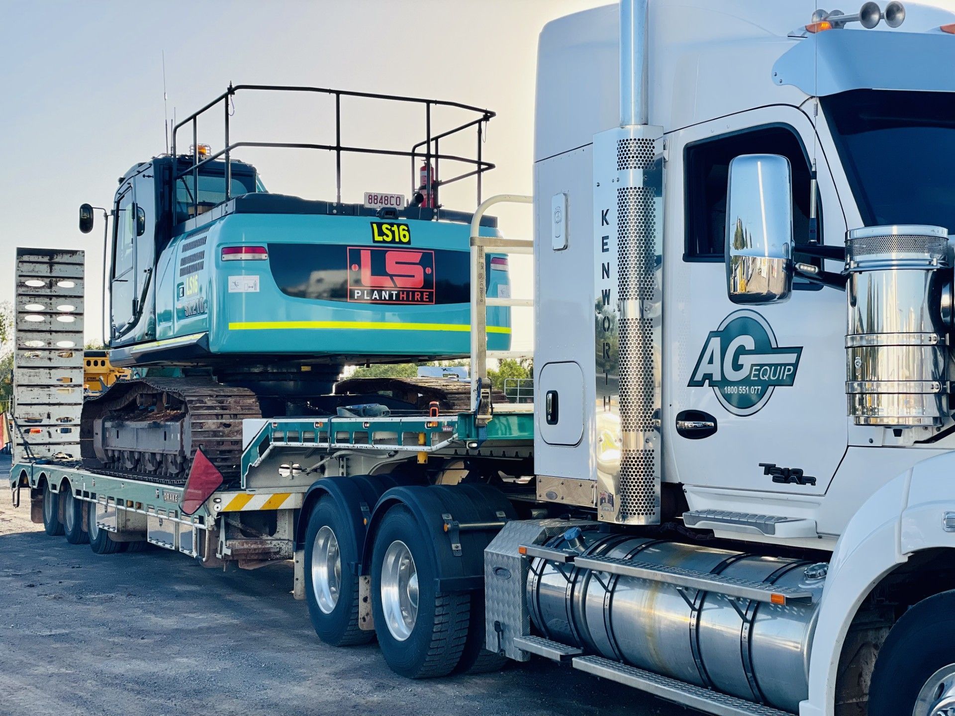 Yellow Loader Dumping Material Into a Blue Truck Bed on a Gravel Surface — LS Plant Hire in Calliope, QLD