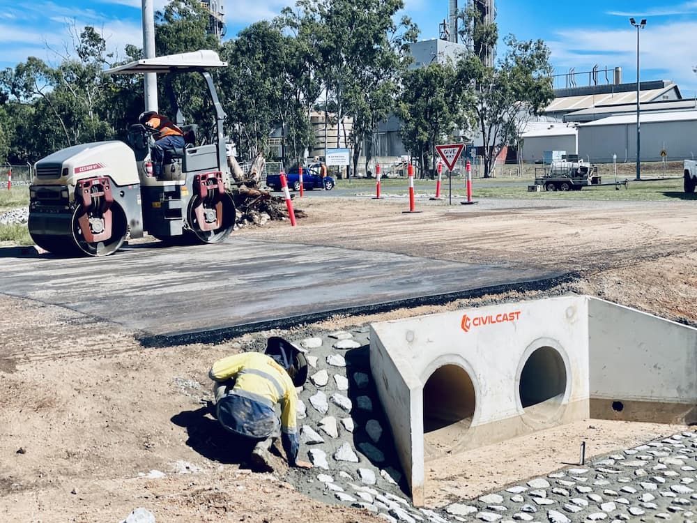 Road Construction: Asphalt Roller, Worker Near Culvert, Construction Zone — LS Plant Hire in Calliope, QLD