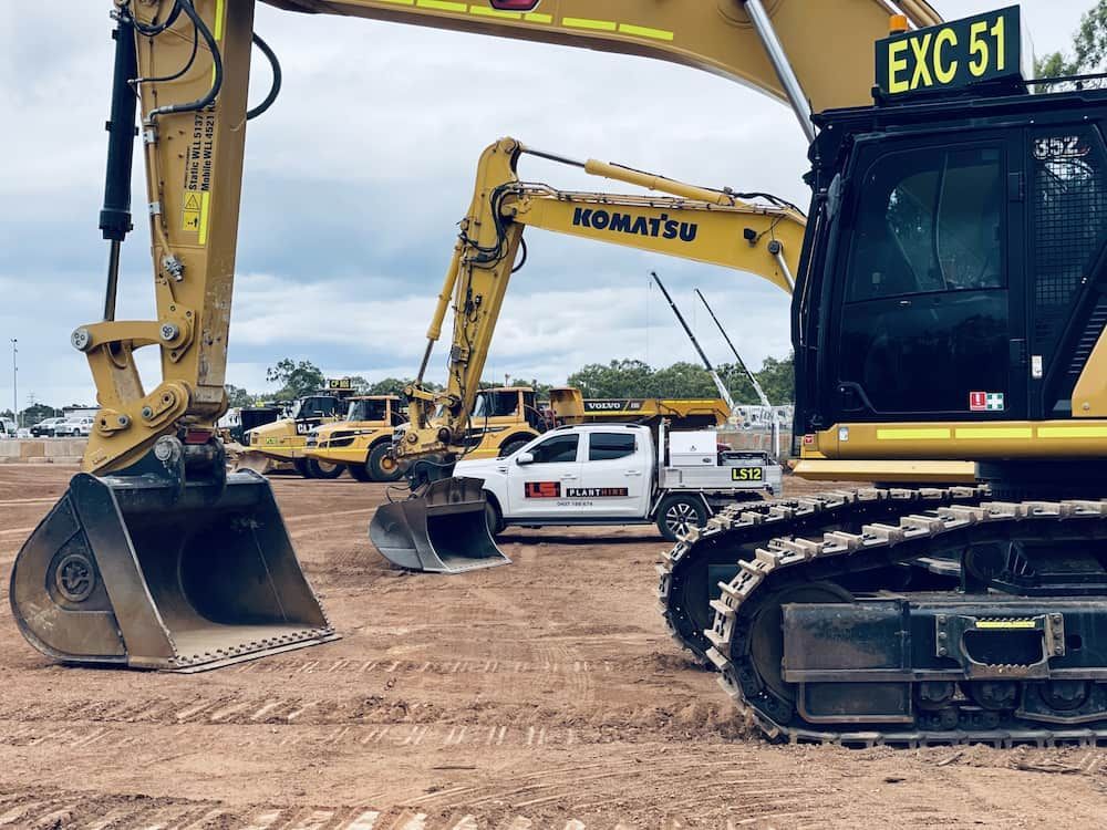 Yellow Komatsu Excavator on a Construction Site, With a White Truck and Other — LS Plant Hire in Calliope, QLD