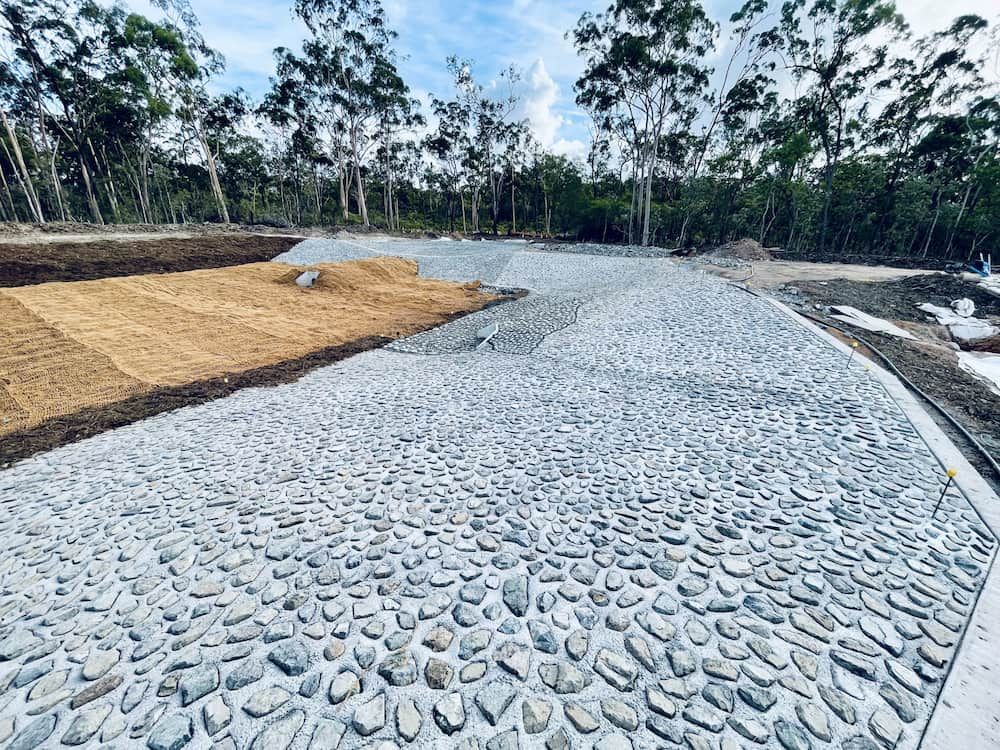 Stone-covered Slope and a Section With Soil and Straw — LS Plant Hire in Calliope, QLD