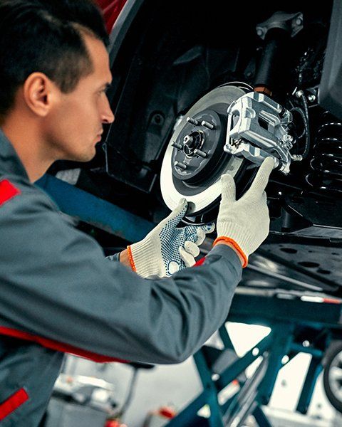 Mechanic Inspecting Car Brake | Aiken, SC | Morris Tire & Auto