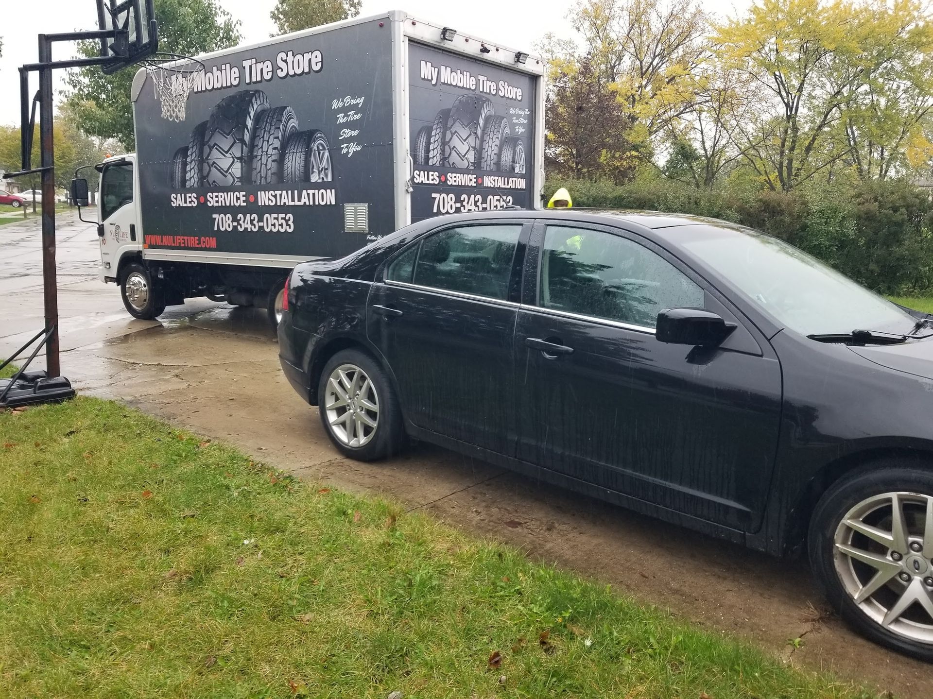 A pile of tires stacked on top of each other in a garage.