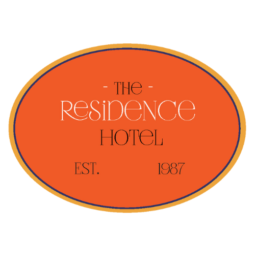 Logo for The Residence Hotel, an oval shape with an orange background and the hotel's name in white text, established in 1987.