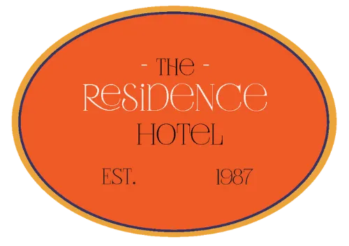 Logo for The Residence Hotel: an orange oval with a brown border, containing white text 