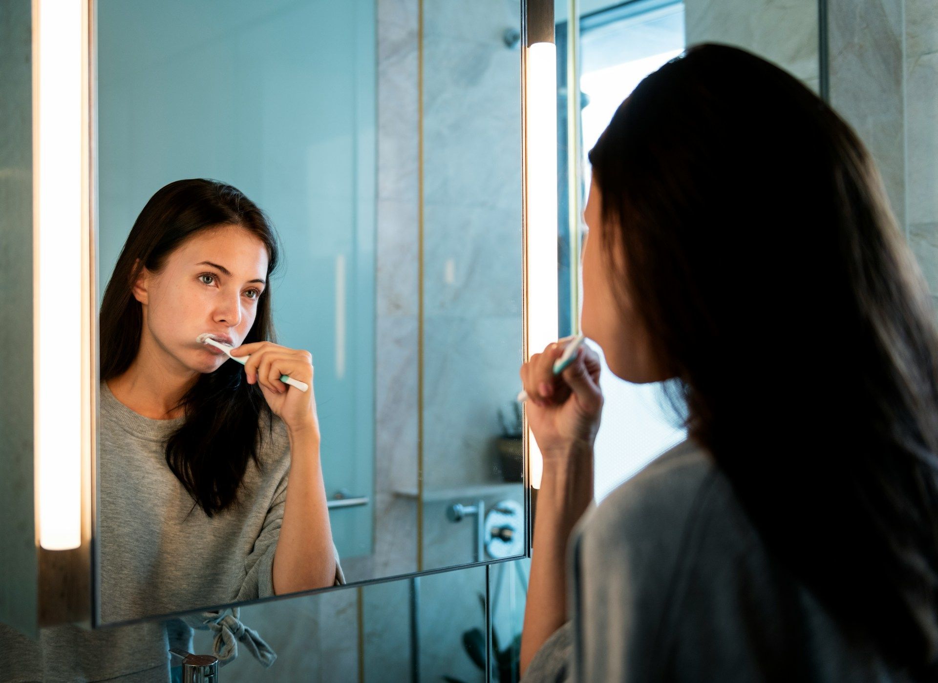 woman brushing teeth