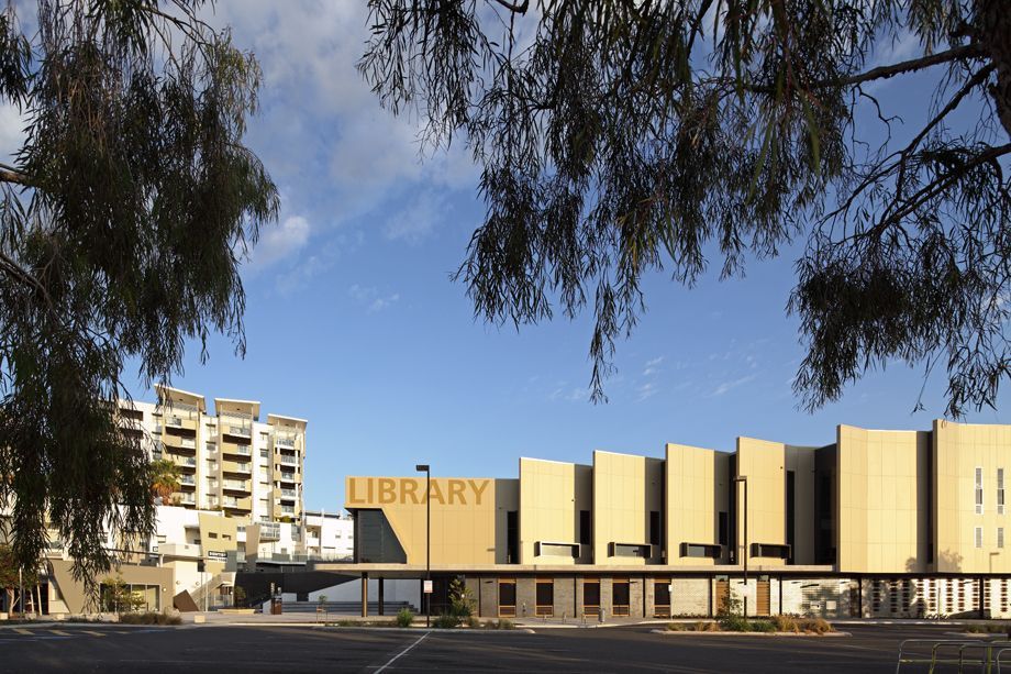 An aerial view of a shopping center surrounded by trees and buildings.
