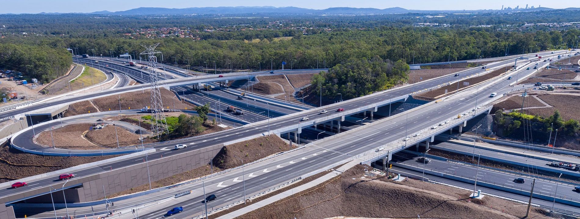 An aerial view of a highway intersection surrounded by trees.