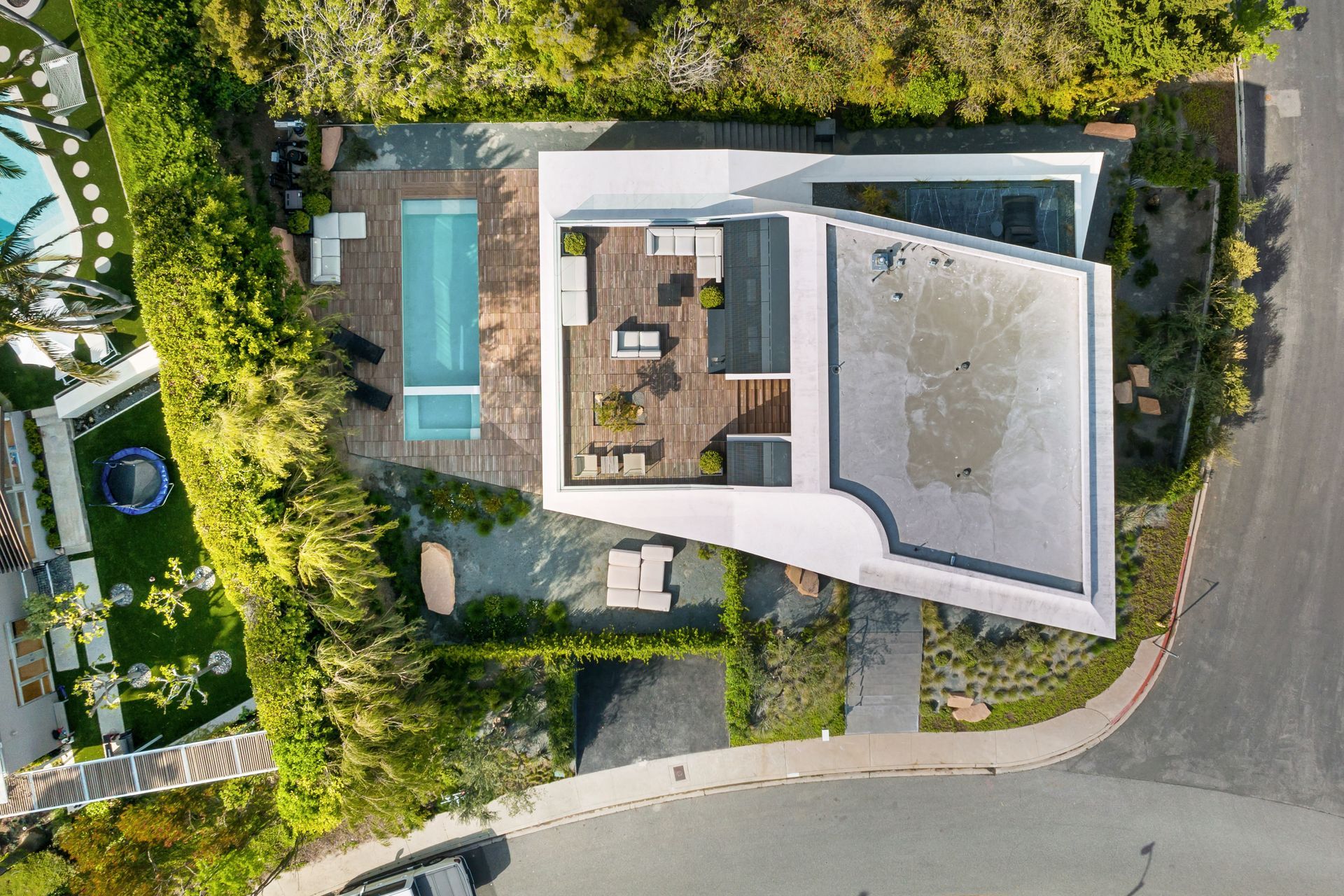 An aerial view of a house with a pool in the backyard