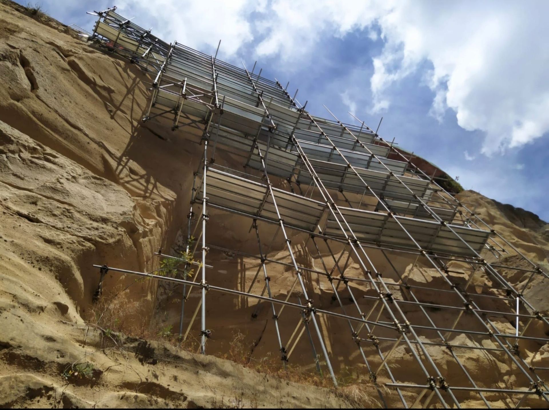 Una grande impalcatura è posta in cima a una collina rocciosa