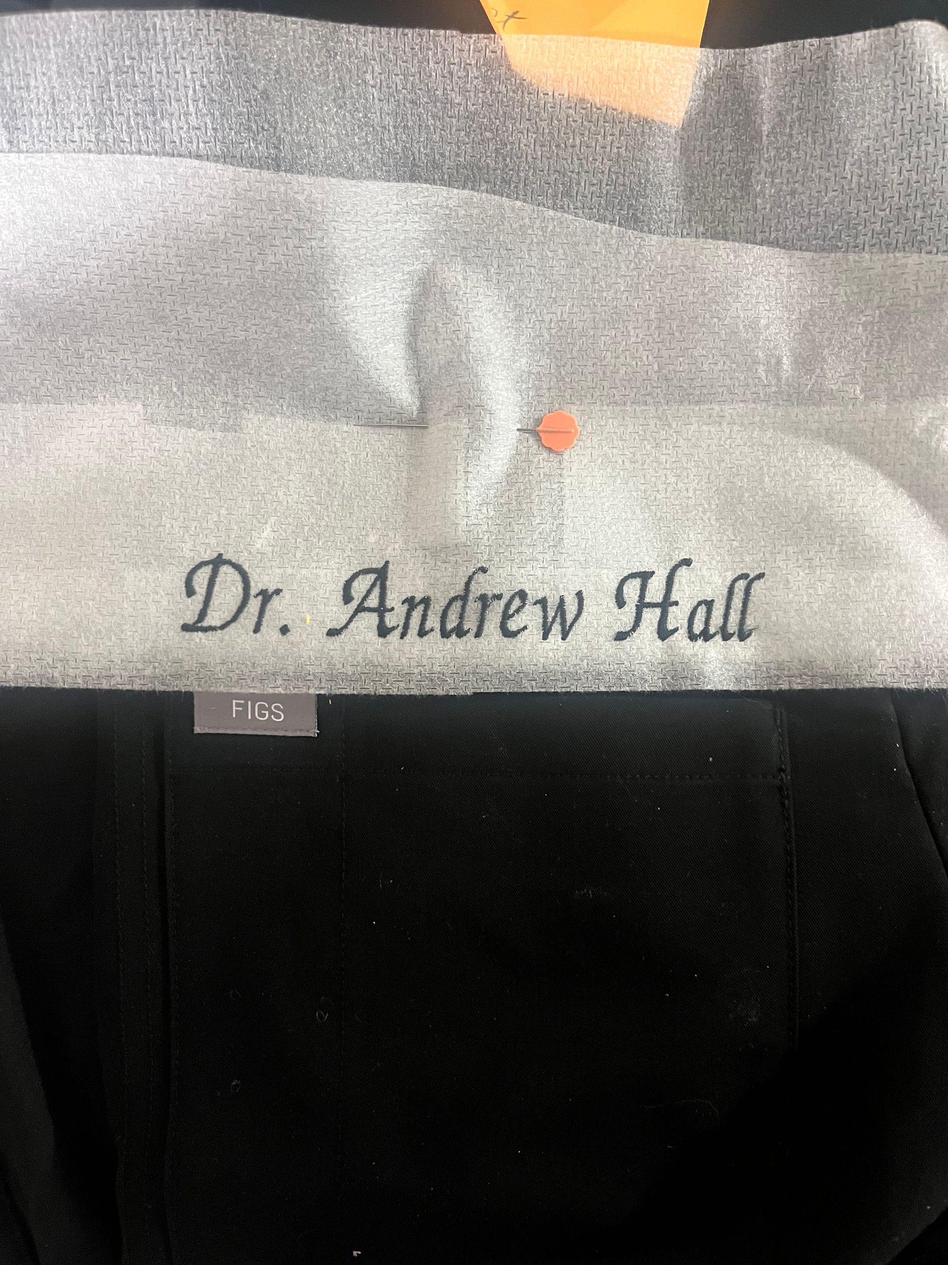 A black shirt embroidered on it