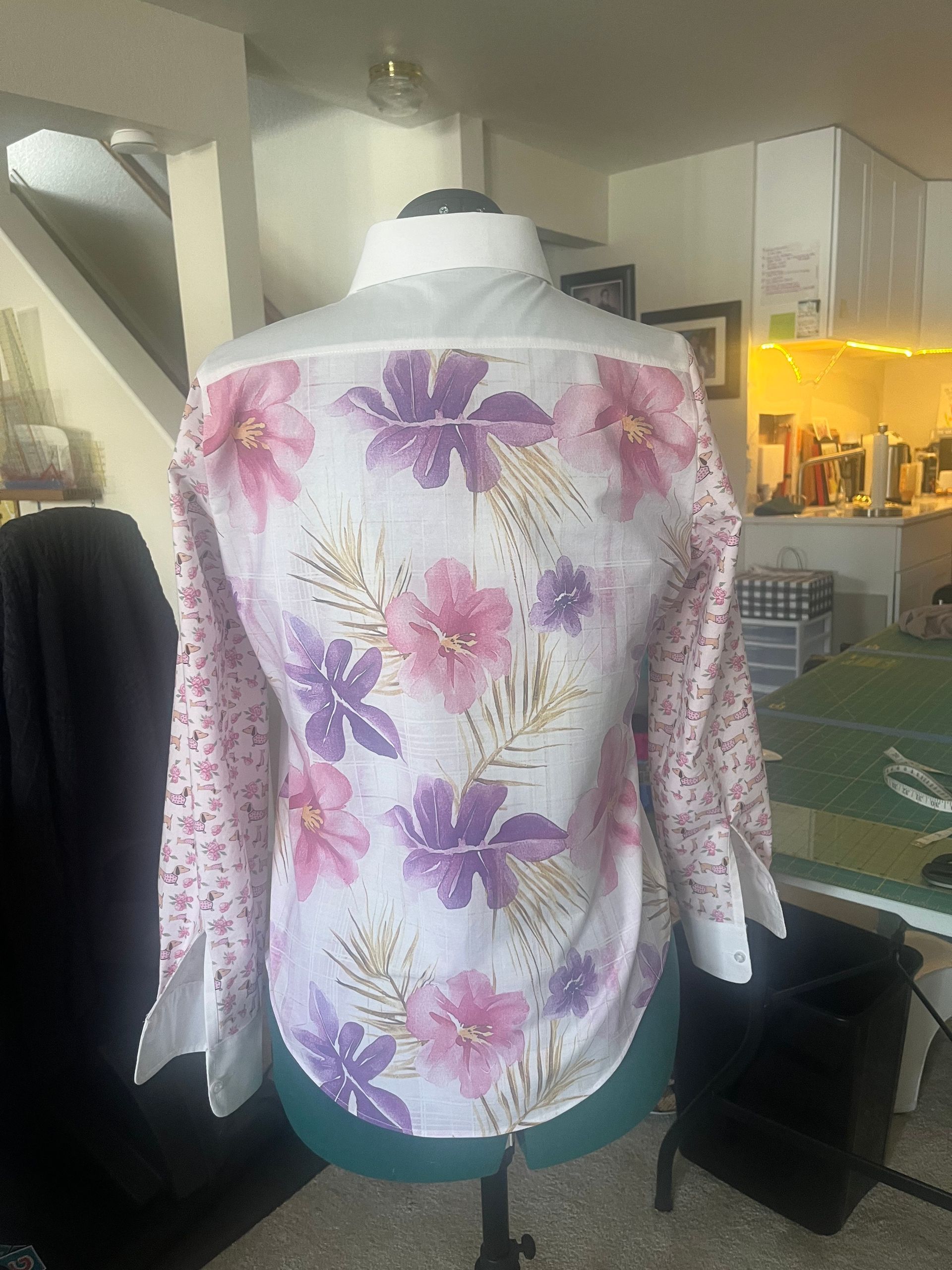 A white shirt with pink and purple flowers