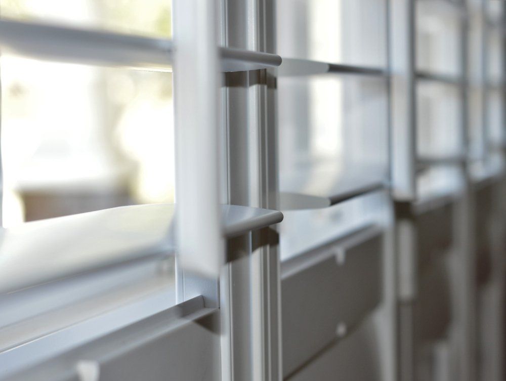 A Close Up of a Metal Railing With a Window in the Background — Mareeba Floor Coverings Centre in Tablelands, QLD