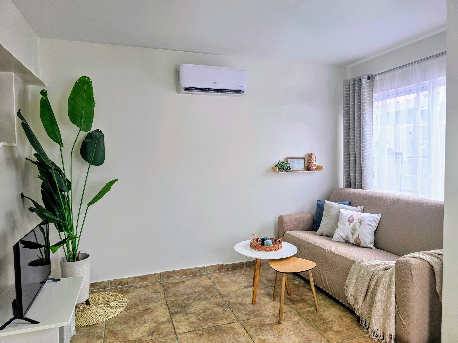 A living room with a table and chairs and a couch.