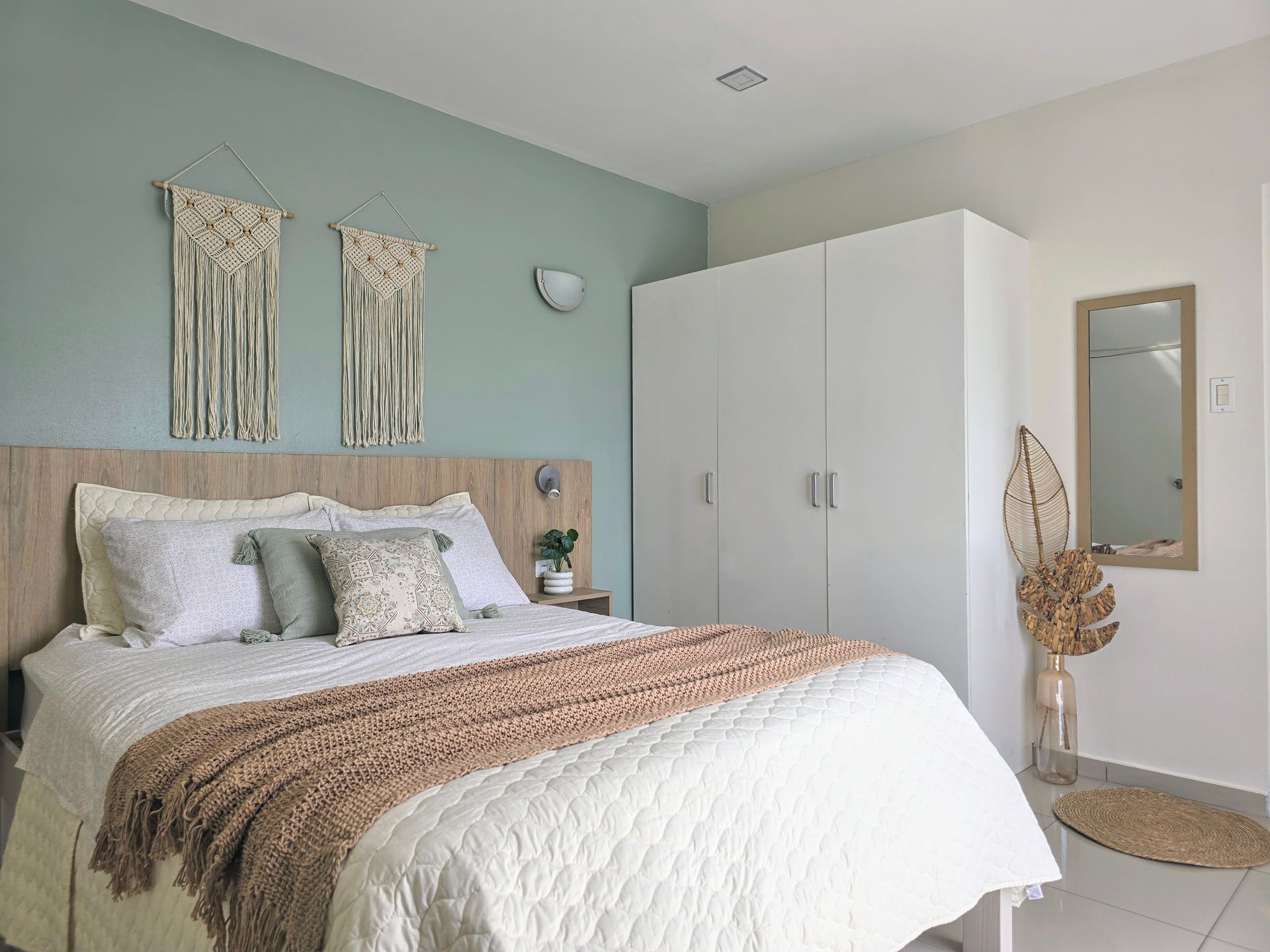 A bedroom with a king size bed and a flat screen tv.