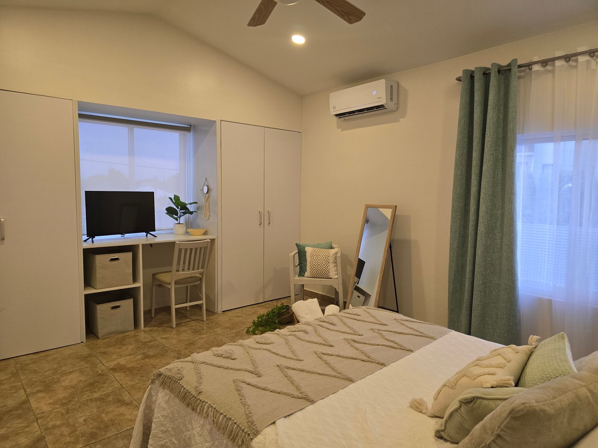 A living room with a couch , table and chairs.
