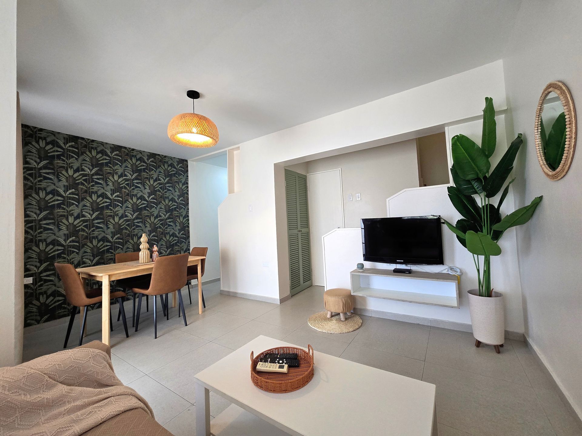 A living room with a couch , table , and television.