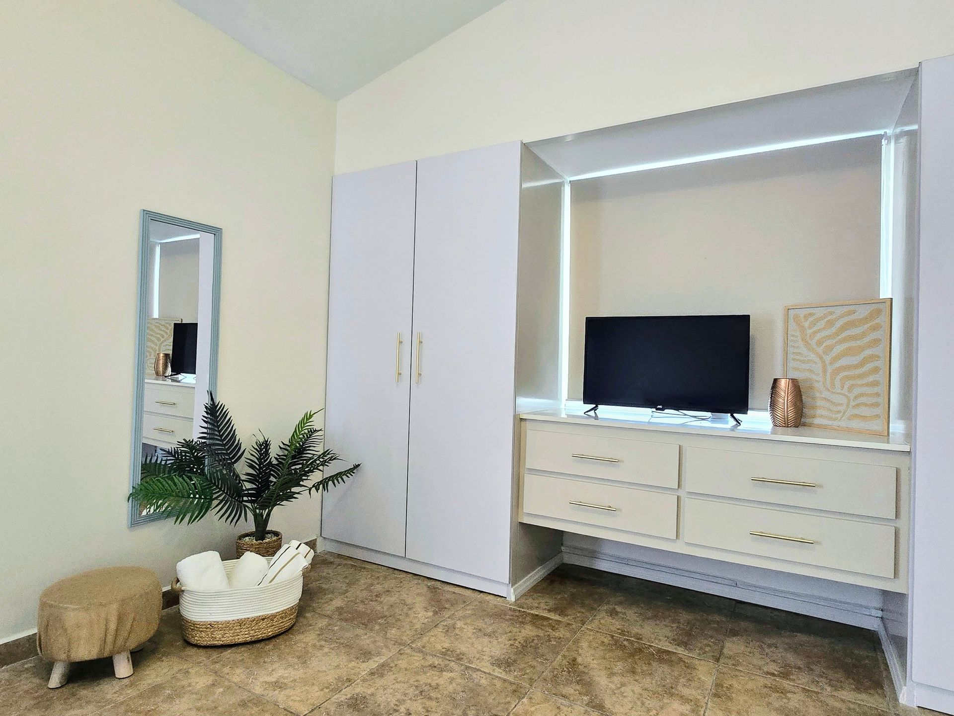 A bedroom with a bed , chair and television.