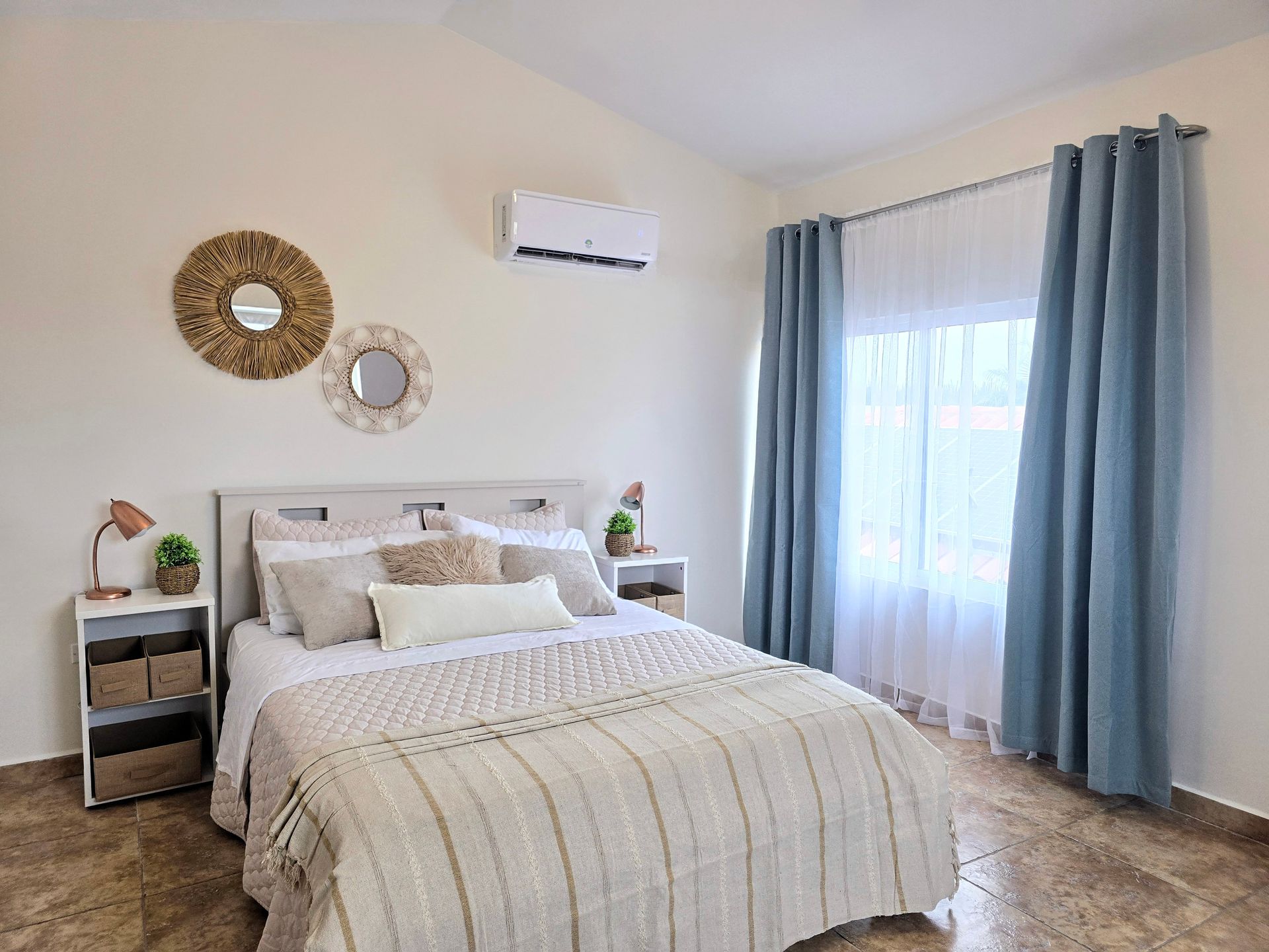 A bedroom with a large bed and a window.