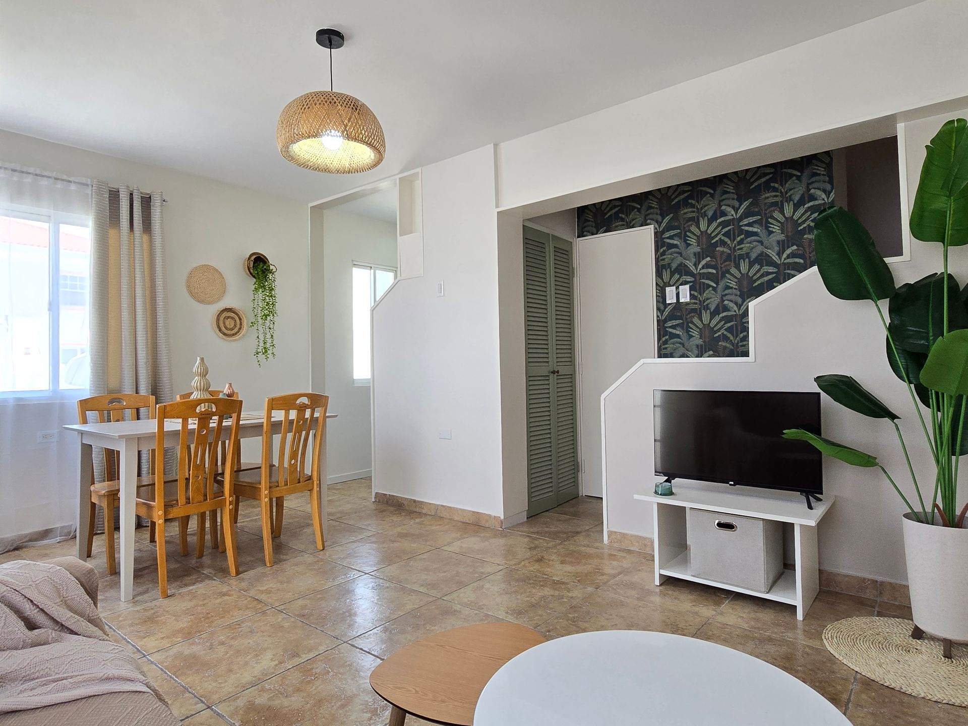 A living room with a couch , table and chairs.