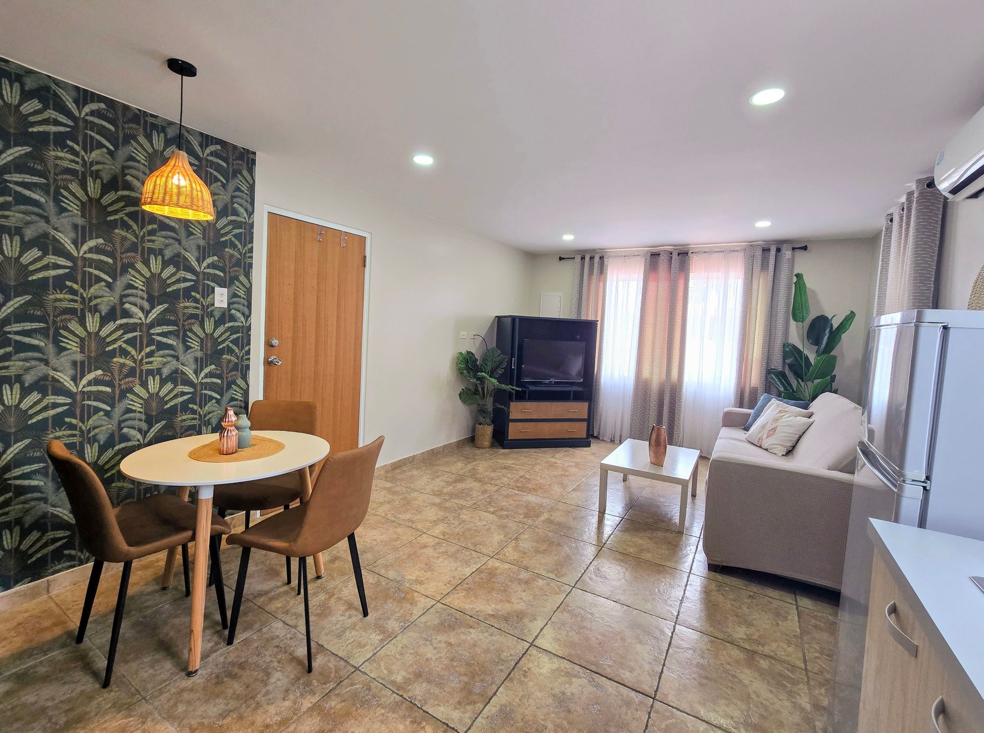 A bedroom with a bed , nightstands , and a window.