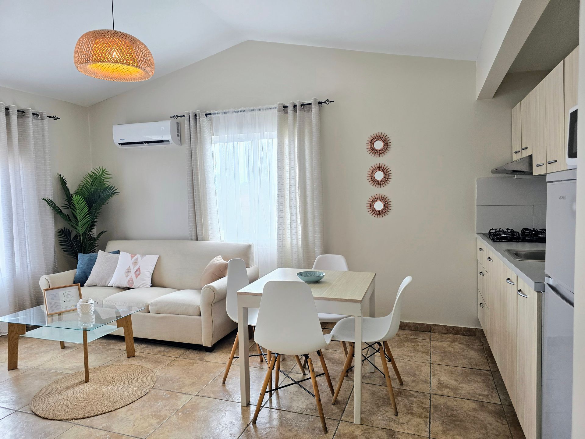 A living room with a red couch , table and chairs.