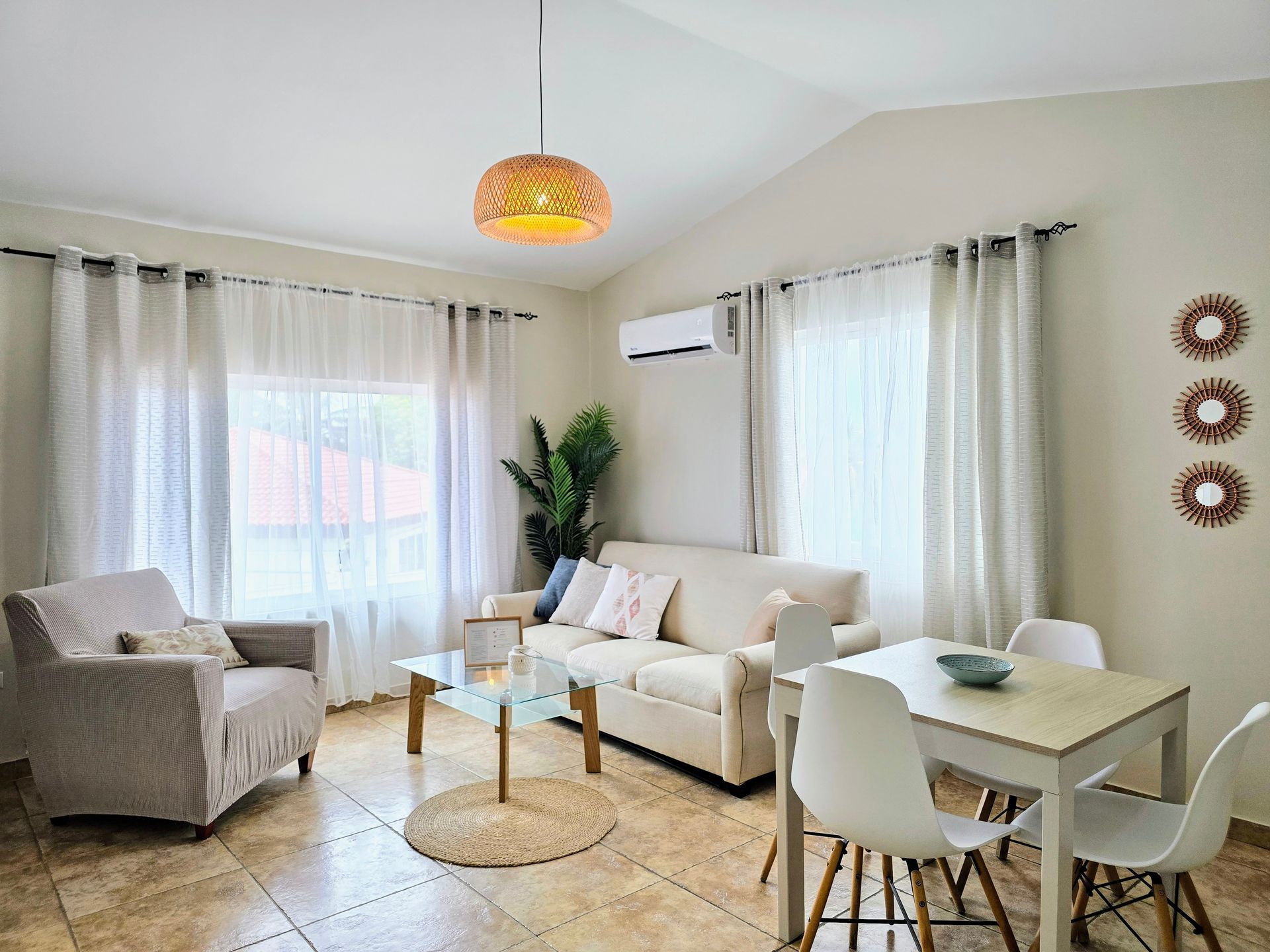 A bedroom with a bed , nightstands , lamps and a window.