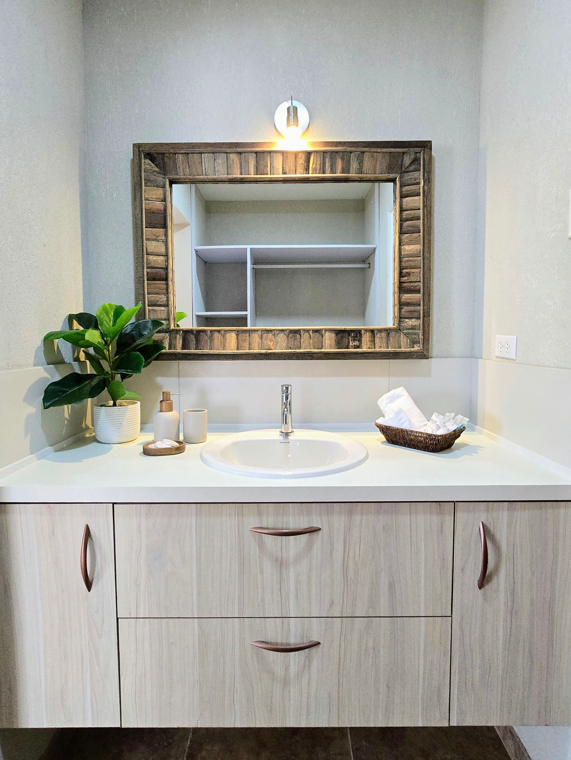 A living room with a couch and a table with a plant on it