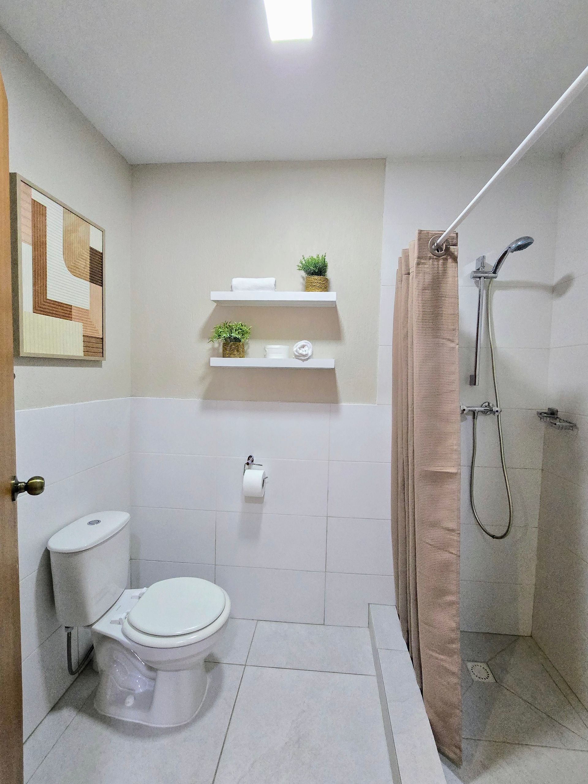 A living room with a table and chairs and a refrigerator.