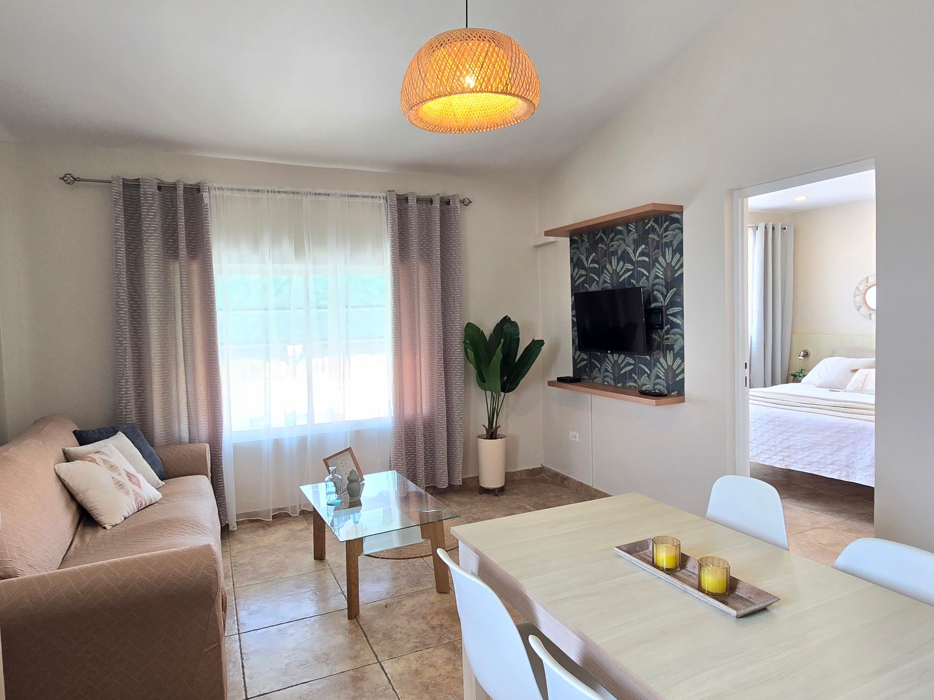 A living room with a table , chairs , and a couch.