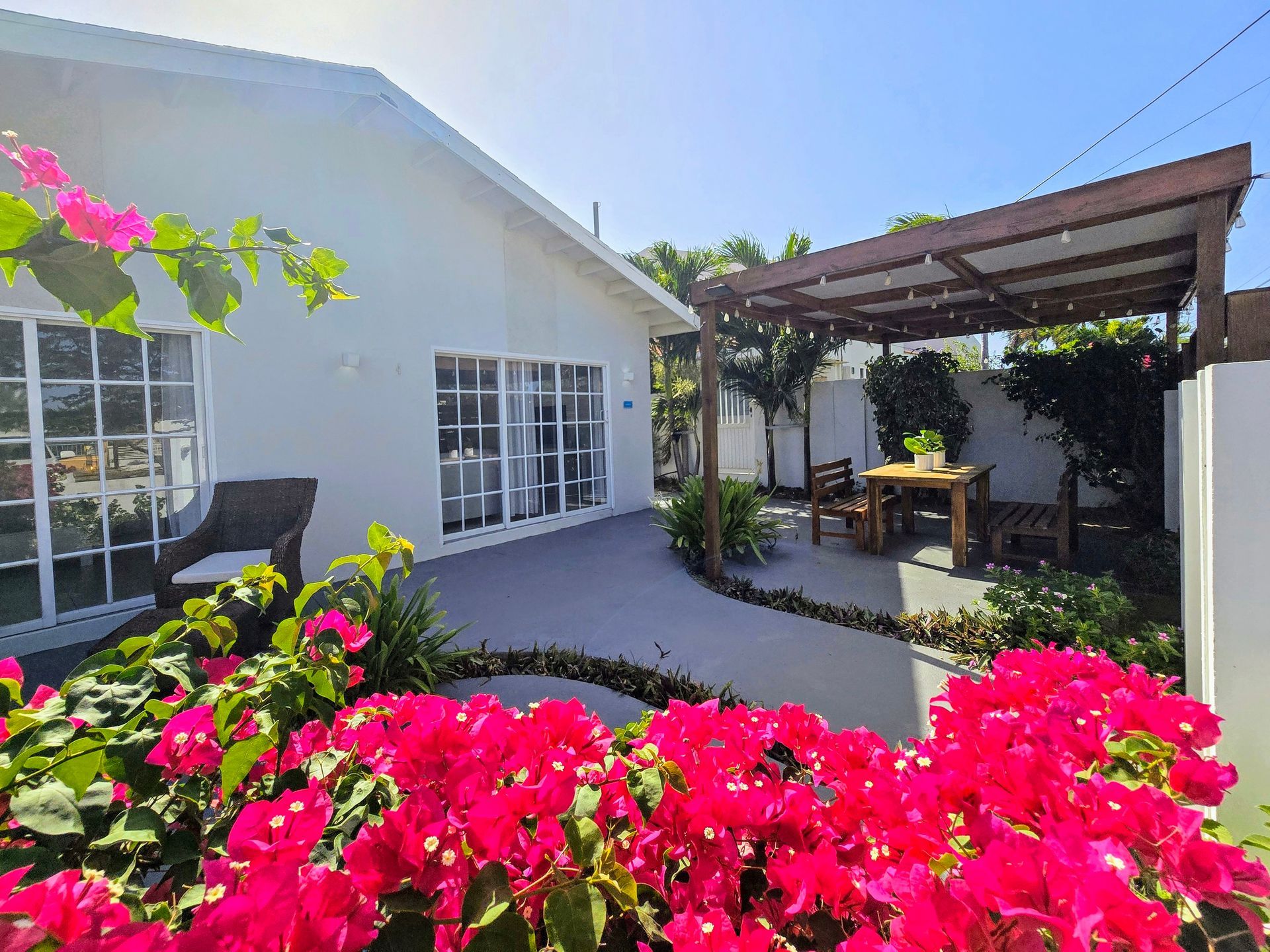 A living room with a table and chairs and a couch.