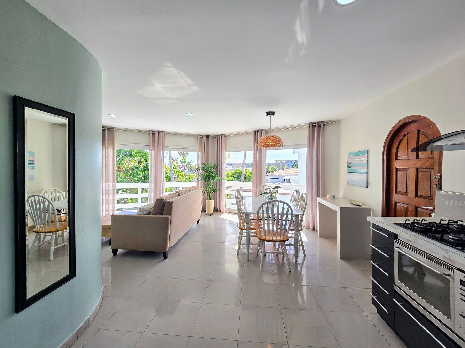 A living room with a couch , table and chairs.