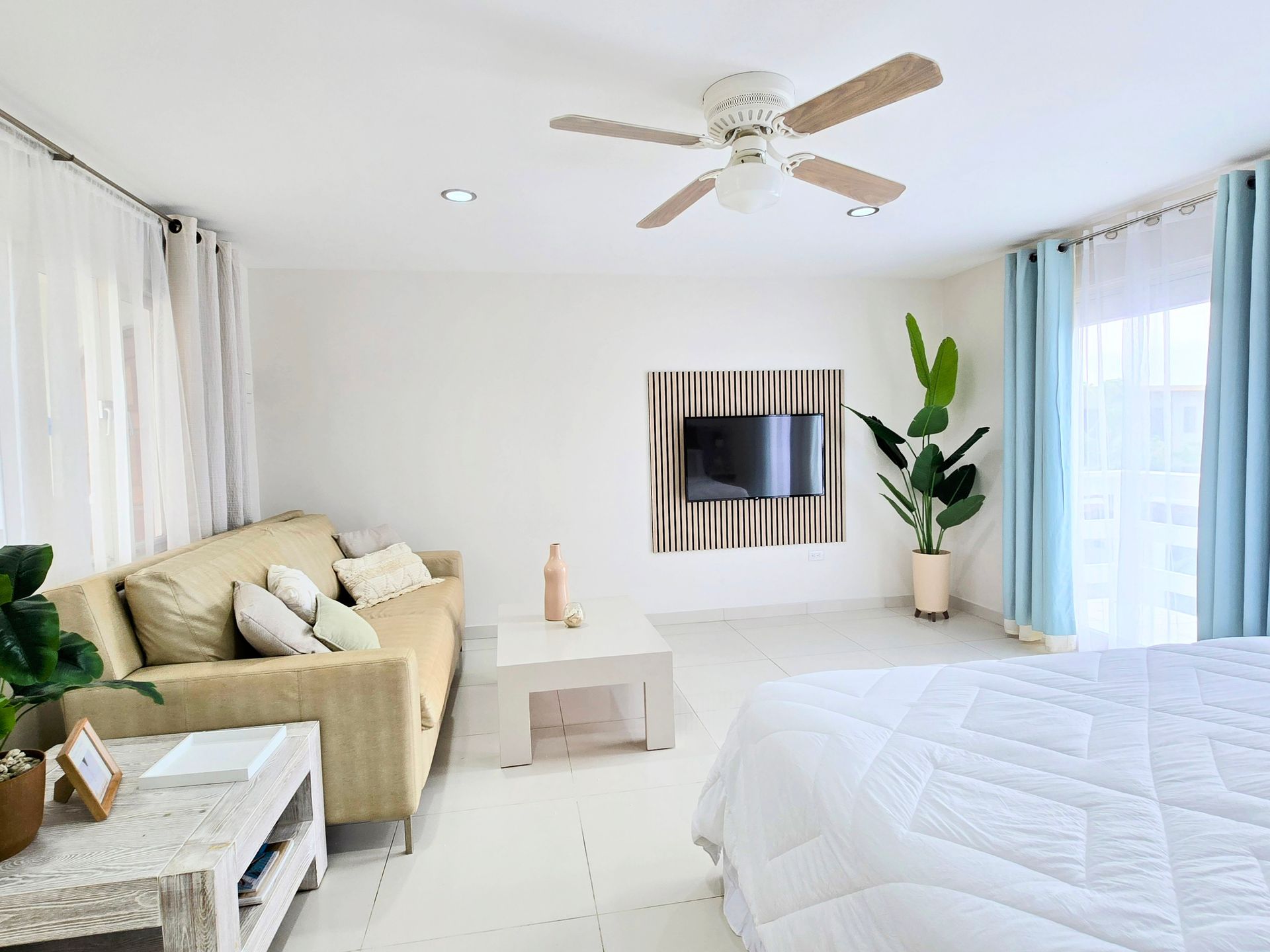 A bedroom with a king size bed and a flat screen tv.