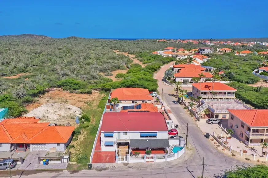 An aerial view of a residential area with lots of houses and trees.