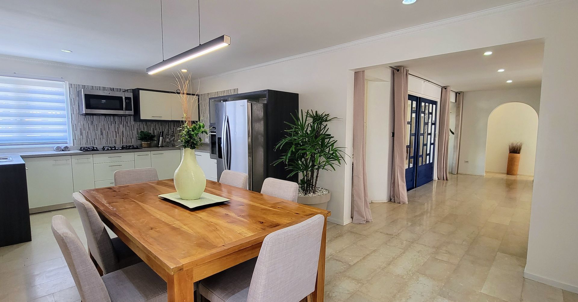 There is a dining table and chairs in the middle of the room.