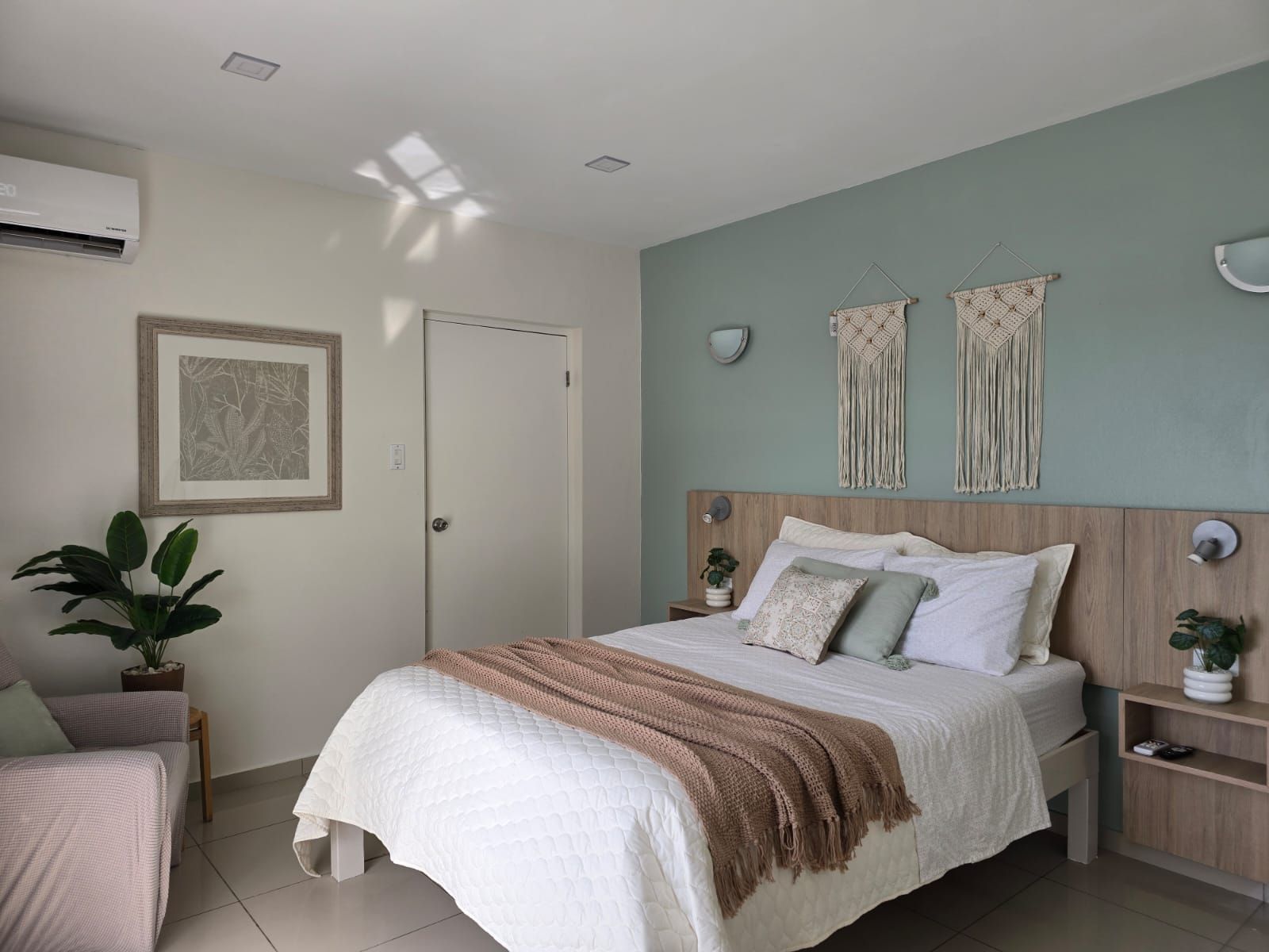 A bedroom with a bed and a couch in it