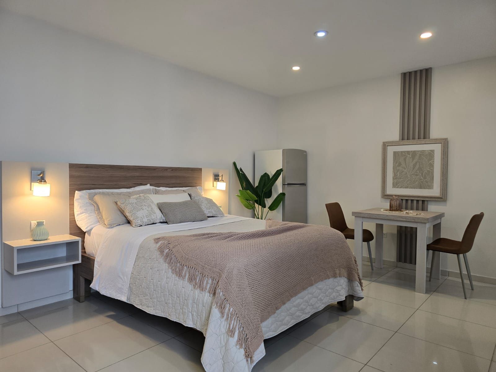 A bedroom with a bed , couch , desk and television.