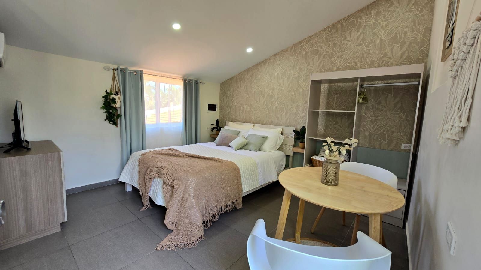 Two people are sitting on lounge chairs near a swimming pool