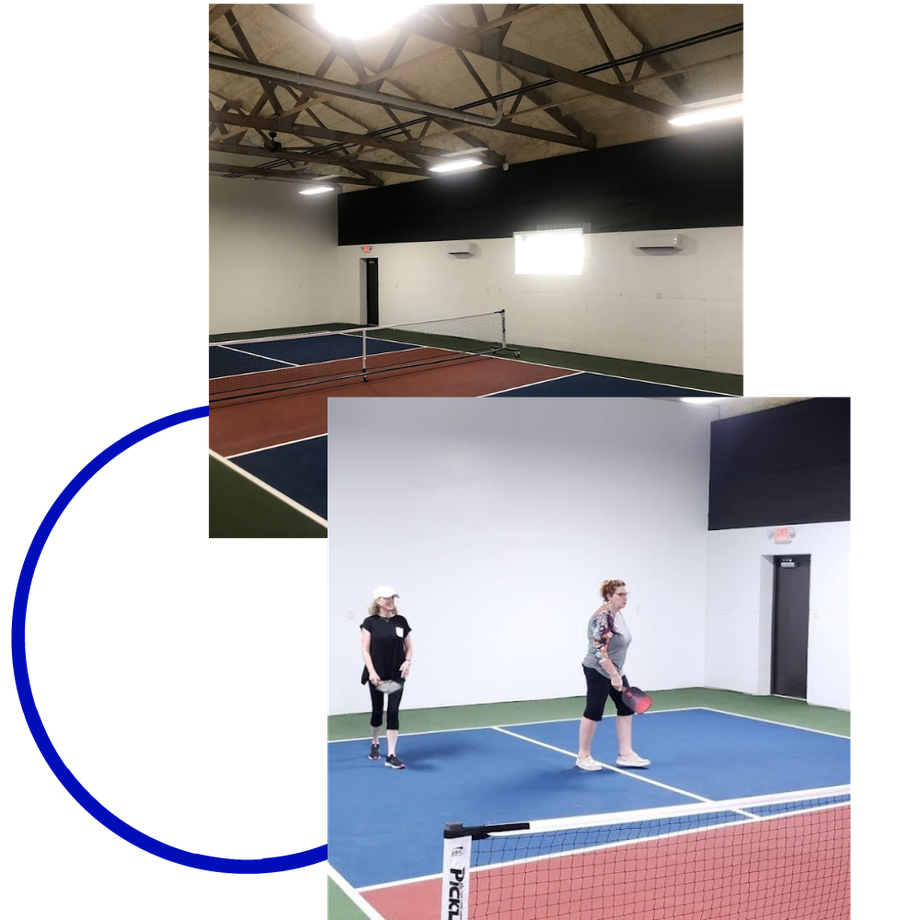 White minivans parked in a lot. Gray sky, green accents, and building on right.