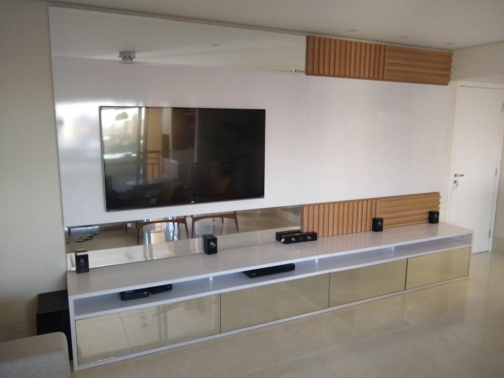 Uma sala de estar com TV de tela plana na parede.