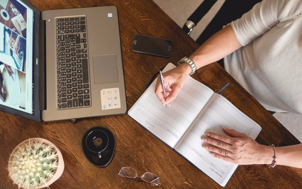 Proofreader reviewing text with a pen in hand, carefully editing the document