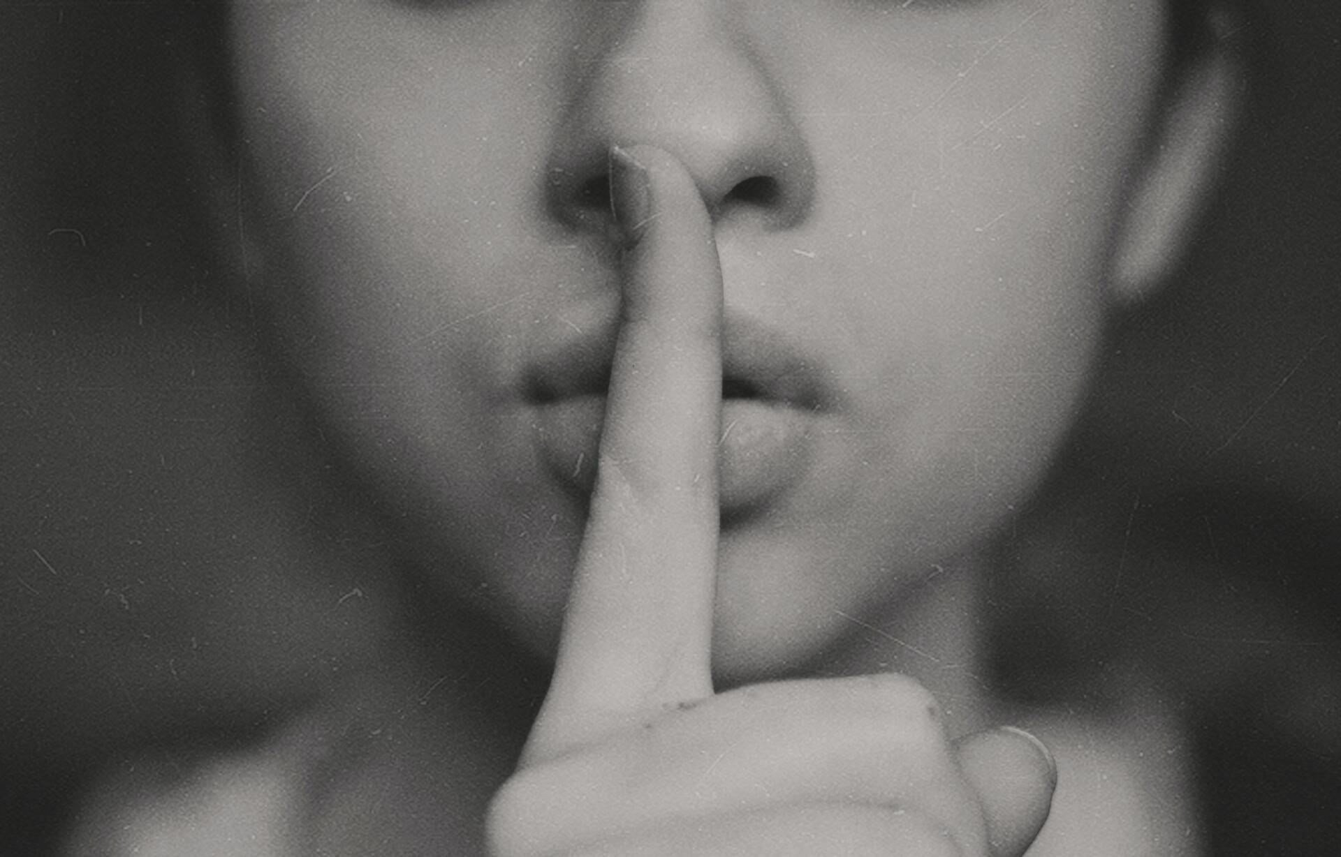 a finger against lips saying shhh