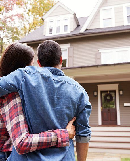 Loving Couple Looking At House — Everett, WA — Vanguard Home Buyers