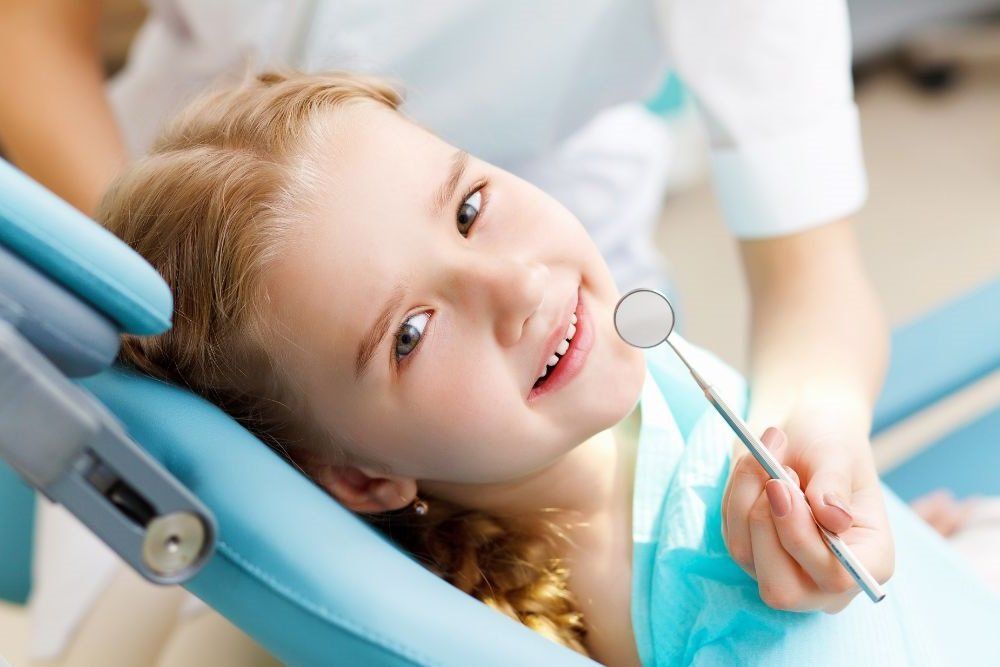 Smiling young woman receiving dental checkup