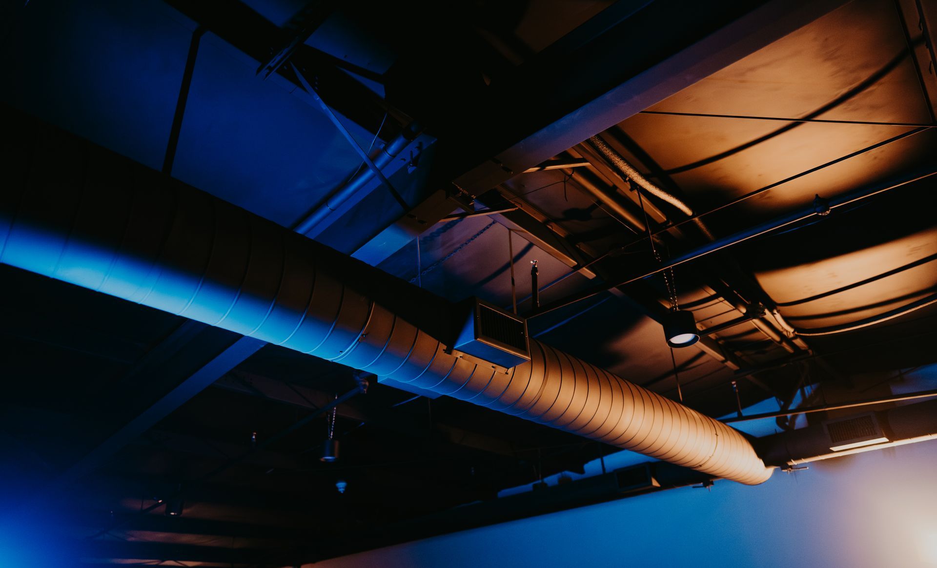 A large pipe is hanging from the ceiling of a building.