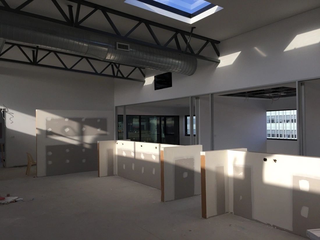 A large empty room with a skylight in the ceiling